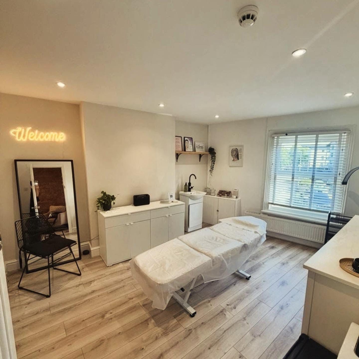 Nichola Colligan's calm, private treatment room in West Kirby with a treatment couch and a welcome sign